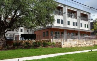 building facades in brown, grey, and white at Settler South Congress in Austin, TX