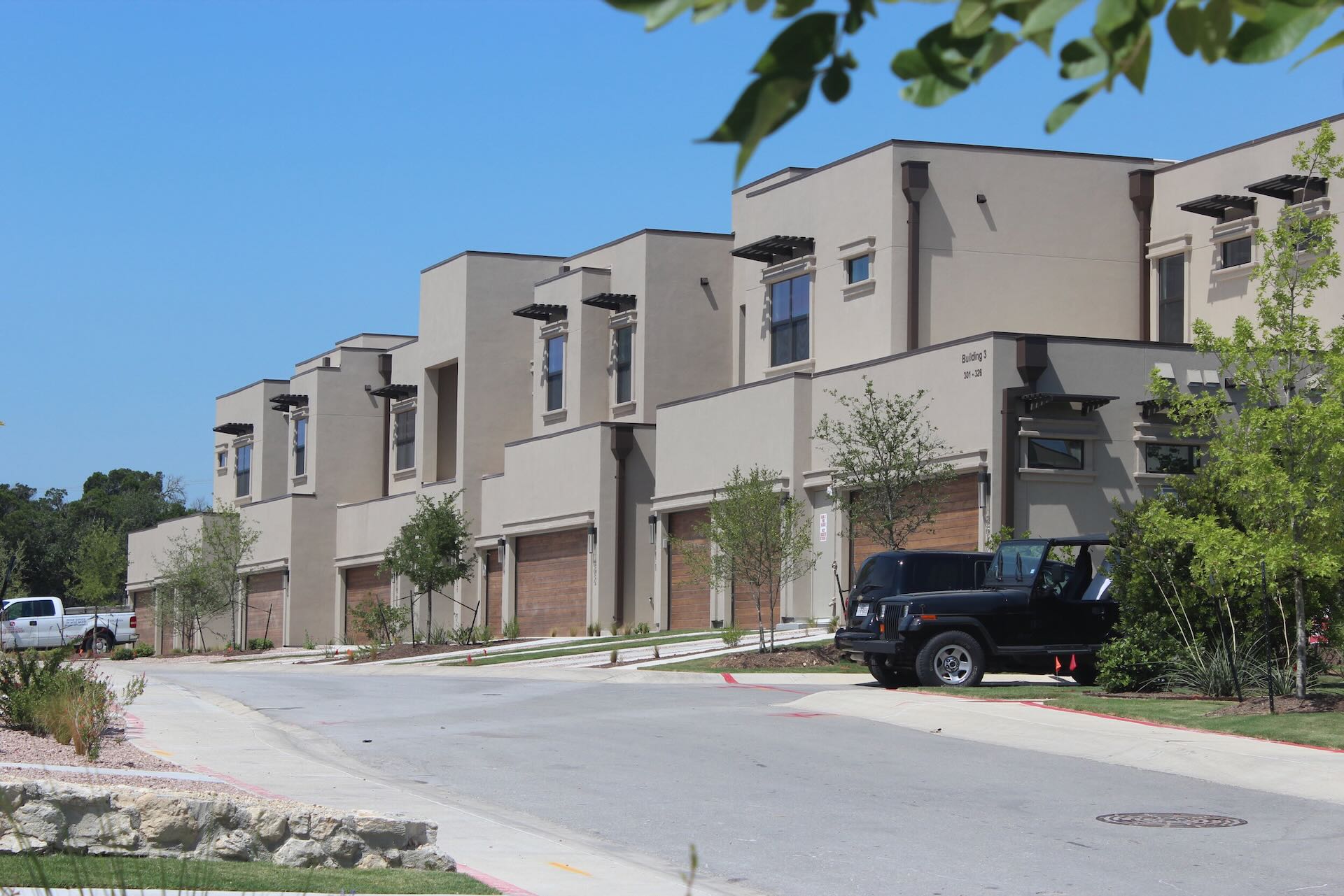 condo exteriors with parked cars at The Enclave at Escondera in TX